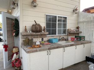 Outdoor kitchen with lots of storage, sink, and garbage disposal.
